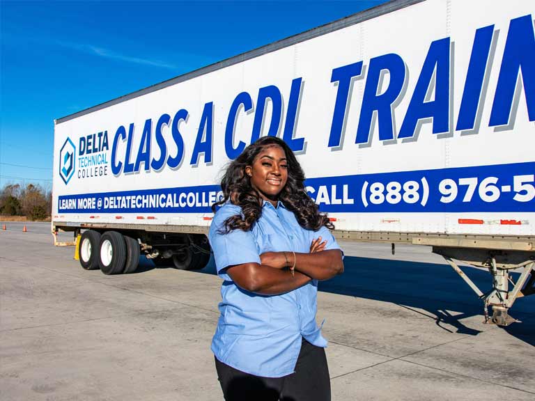CDL Student standing next to training vehicle